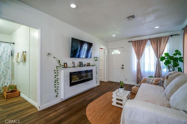 201 E Olive St, San Bernardino, CA 92410 - living area with dark wood finished floors, baseboards, and visible vents