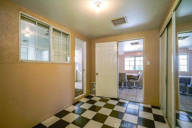 201 E Olive St, San Bernardino, CA 92410 - doorway featuring a healthy amount of sunlight, tile patterned floors, and visible vents