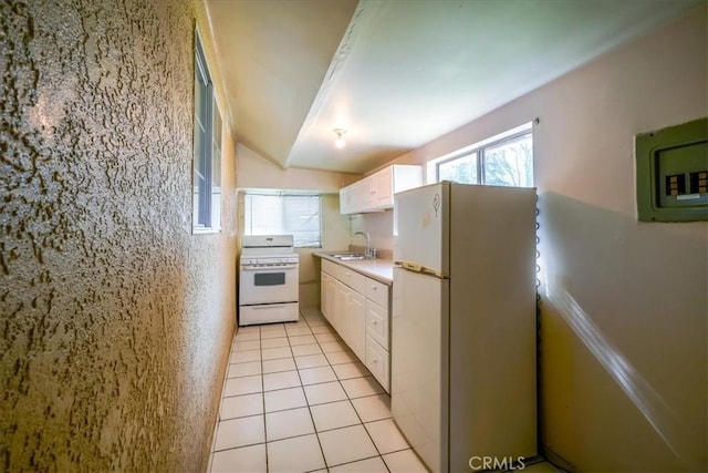 201 E Olive St, San Bernardino, CA 92410 - kitchen with light countertops, a sink, white cabinetry, and white appliances