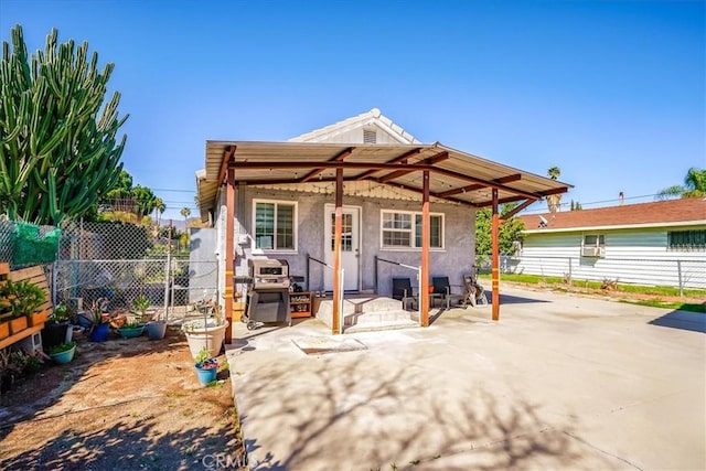 201 E Olive St, San Bernardino, CA 92410 - rear view of house with stucco siding, fence, and a patio