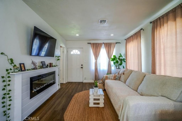 201 E Olive St, San Bernardino, CA 92410 - living area with dark wood-style floors, a glass covered fireplace, baseboards, visible vents, and recessed lighting