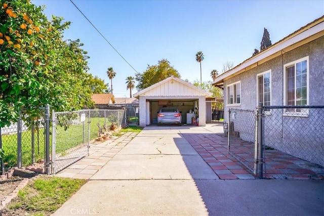 201 E Olive St, San Bernardino, CA 92410 - exterior space with a gate, a detached garage, fence, and an outdoor structure