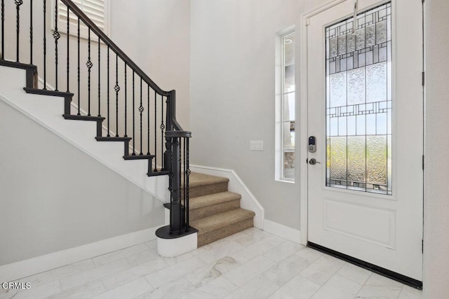 4111 Adriatic St, Oxnard, CA 93035 - foyer entrance featuring marble look tile flooring, baseboards, and stairway