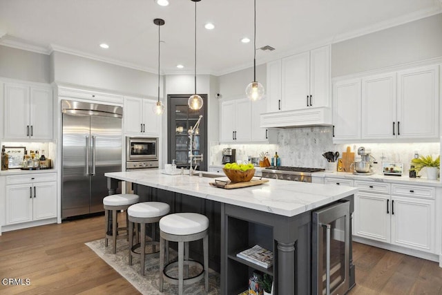 4111 Adriatic St, Oxnard, CA 93035 - kitchen featuring built in appliances, beverage cooler, custom exhaust hood, open shelves, and backsplash