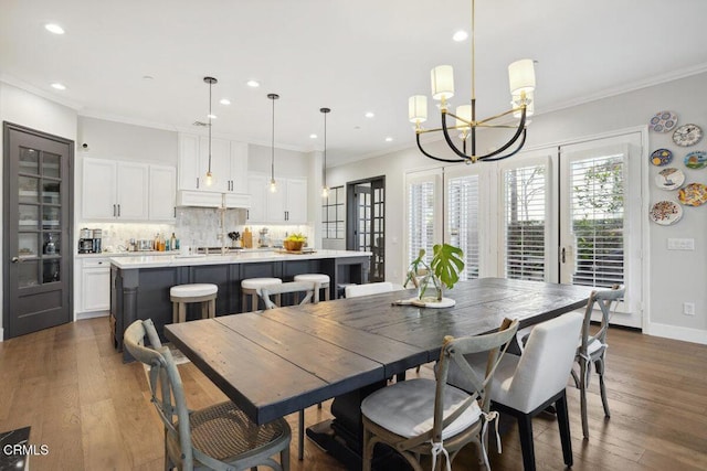 4111 Adriatic St, Oxnard, CA 93035 - dining area featuring recessed lighting, a chandelier, crown molding, dark wood-style flooring, and baseboards