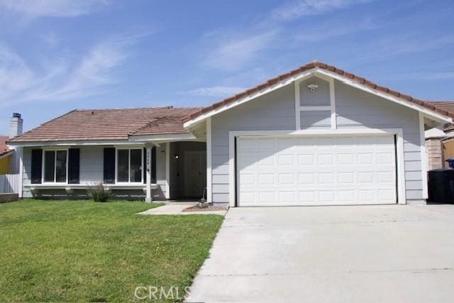 ranch-style home featuring an attached garage, concrete driveway, a tile roof, and a front lawn