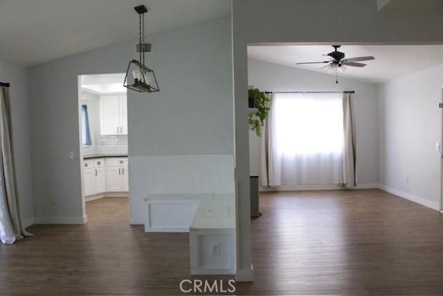 interior space with a healthy amount of sunlight, dark wood-style floors, and lofted ceiling