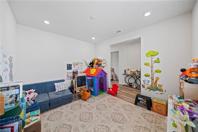 game room with recessed lighting, wood finished floors, and visible vents