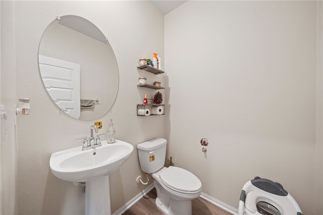 11638 Zoeller St, Beaumont, CA 92223 - half bathroom with wood finished floors, toilet, and baseboards