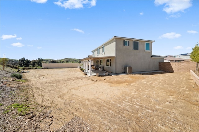 back of property featuring a fenced backyard, a patio area, and stucco siding