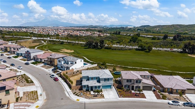 birds eye view of property with a mountain view, golf course view, and a residential view