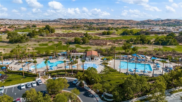 drone / aerial view featuring a mountain view and view of golf course