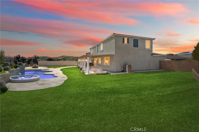 11638 Zoeller St, Beaumont, CA 92223 - back of property at dusk featuring a patio area and stucco siding