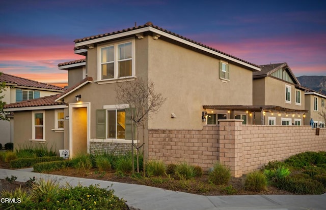 1926S Pump House Ln, Santa Paula, CA 93060 - property exterior at dusk featuring stucco siding, a tile roof, and fence