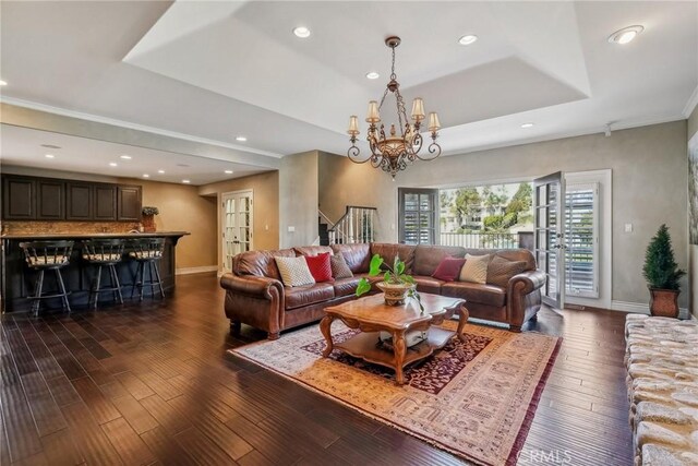 1547 Via Coronel, Palos Verdes Estates, CA 90274 - living room with a tray ceiling, dark wood-style flooring, baseboards, a chandelier, and stairs