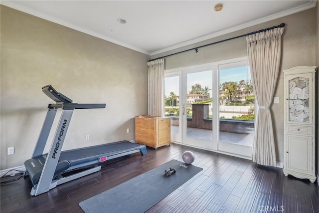 exercise area with ornamental molding and wood finished floors