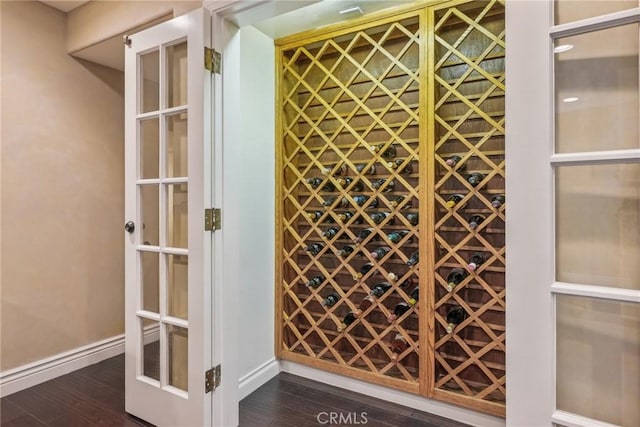 wine cellar with baseboards and dark wood-style floors