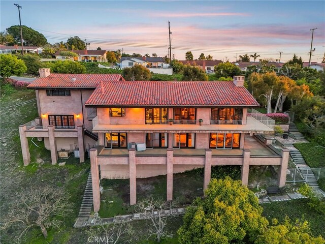 1547 Via Coronel, Palos Verdes Estates, CA 90274 - back of house featuring a tiled roof, stucco siding, a chimney, stairway, and a balcony
