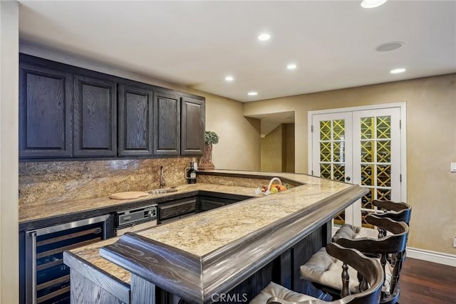 bar with recessed lighting, backsplash, a sink, dark wood-type flooring, and wine cooler