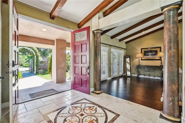 foyer entrance featuring french doors, a healthy amount of sunlight, vaulted ceiling with beams, and decorative columns