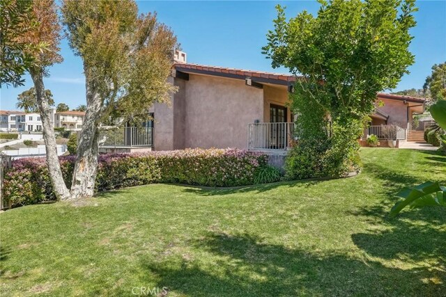 1547 Via Coronel, Palos Verdes Estates, CA 90274 - view of property exterior with a yard, a tile roof, and stucco siding