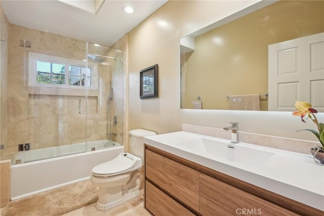 bathroom with shower / bath combination with glass door, toilet, tile patterned flooring, and vanity