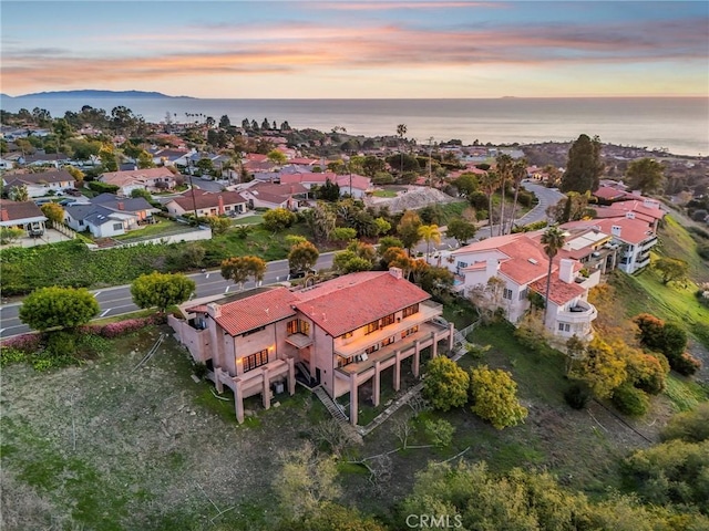 bird's eye view featuring a water view and a residential view