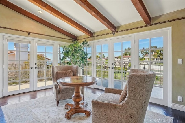 sunroom with beam ceiling and french doors