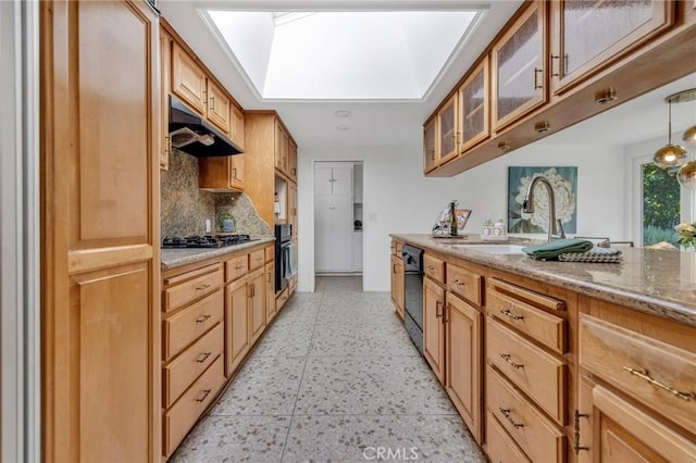 2001 Hacienda Rd, La Habra Heights, CA 90631 - kitchen featuring a skylight, under cabinet range hood, decorative backsplash, glass insert cabinets, and black appliances