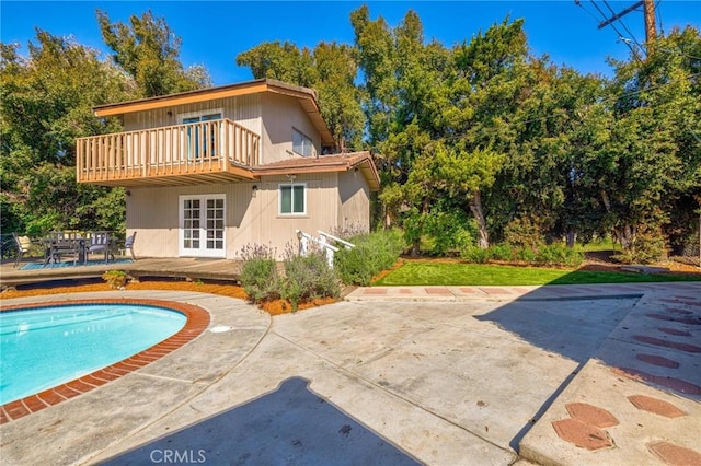 2001 Hacienda Rd, La Habra Heights, CA 90631 - rear view of house with french doors, an outdoor pool, a wooden deck, a patio, and outdoor dining space