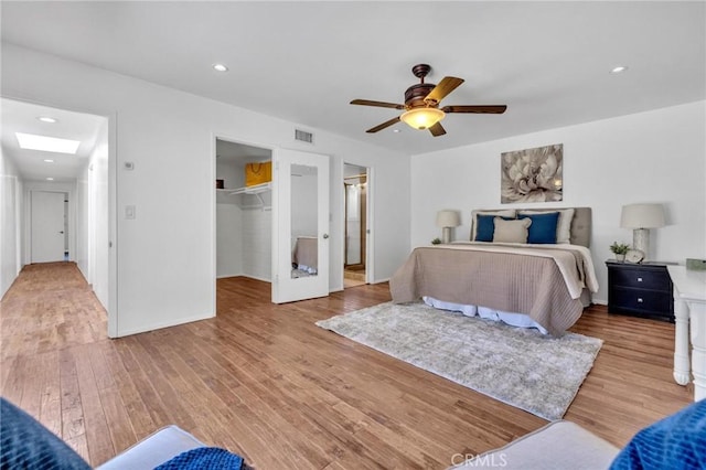 2001 Hacienda Rd, La Habra Heights, CA 90631 - bedroom with wood finished floors, a spacious closet, a ceiling fan, a skylight, and recessed lighting