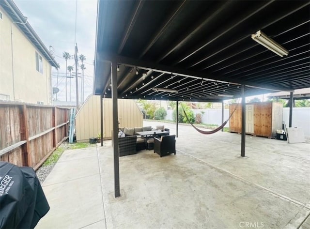 view of patio featuring a fenced backyard, an outdoor living space, and a grill