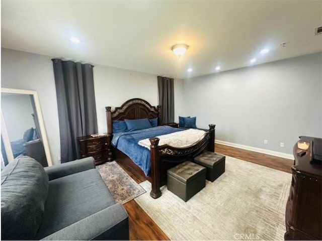 bedroom featuring recessed lighting, baseboards, visible vents, and wood finished floors