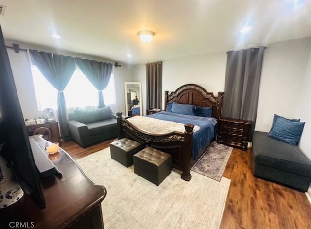 bedroom featuring wood finished floors and visible vents