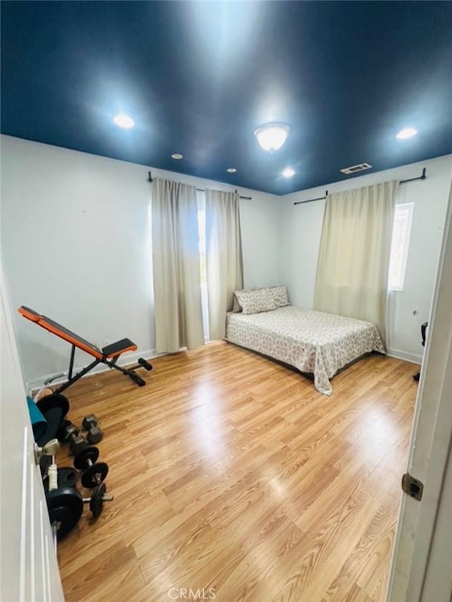 bedroom with recessed lighting, visible vents, and wood finished floors