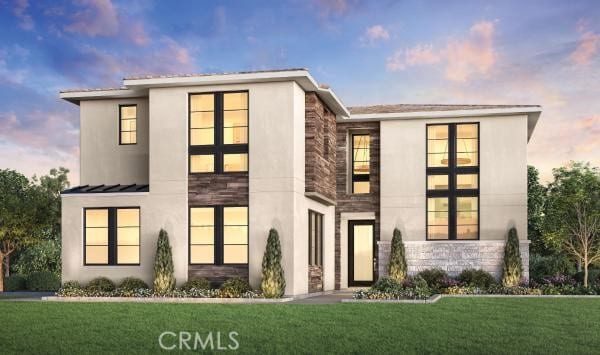 contemporary home with a yard, stone siding, a standing seam roof, and stucco siding
