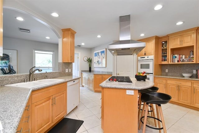 5223 Armida Dr, Woodland Hills, CA 91364 - kitchen with island exhaust hood, white appliances, tasteful backsplash, arched walkways, and recessed lighting