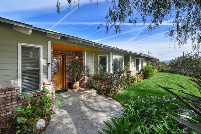 5223 Armida Dr, Woodland Hills, CA 91364 - property entrance with brick siding, covered porch, and a lawn