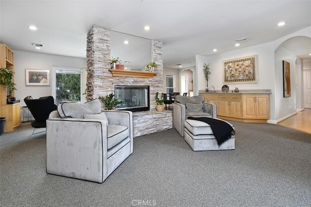 5223 Armida Dr, Woodland Hills, CA 91364 - living area with arched walkways, a fireplace, recessed lighting, and light colored carpet