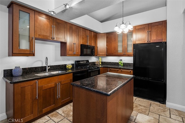 kitchen with stone tile floors, baseboards, a sink, and black appliances