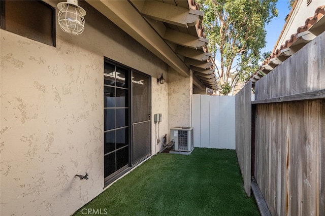 view of yard featuring central air condition unit and fence