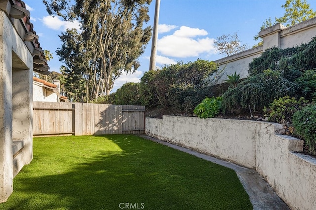view of yard with a fenced backyard