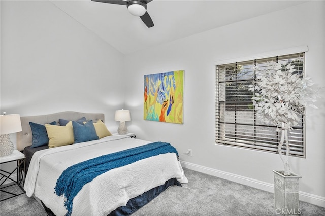 carpeted bedroom featuring lofted ceiling, baseboards, and ceiling fan