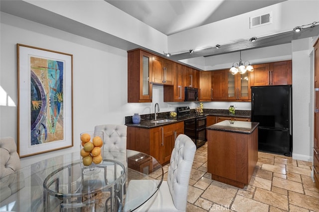 kitchen with glass insert cabinets, visible vents, a sink, and black appliances
