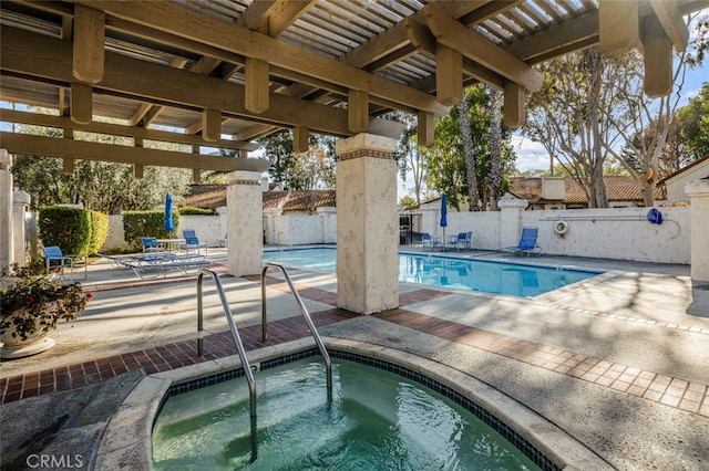 community pool with a fenced backyard, a community hot tub, and a patio