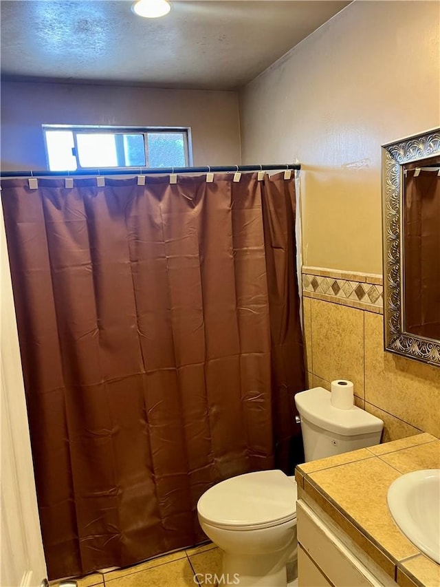 10715 3rd Ave, Hesperia, CA 92345 - full bathroom with vanity, tile walls, wainscoting, curtained shower, and tile patterned flooring