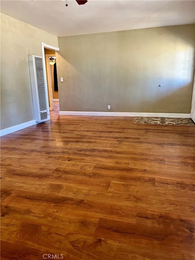 10715 3rd Ave, Hesperia, CA 92345 - empty room featuring a heating unit, wood finished floors, and a ceiling fan
