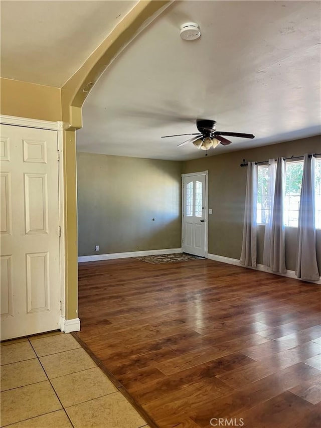 10715 3rd Ave, Hesperia, CA 92345 - empty room with a smoke detector, ceiling fan, light wood finished floors, and arched walkways