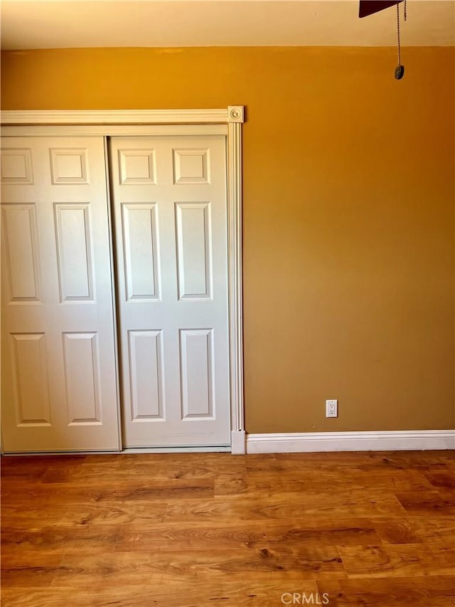 10715 3rd Ave, Hesperia, CA 92345 - unfurnished bedroom featuring a closet and wood finished floors