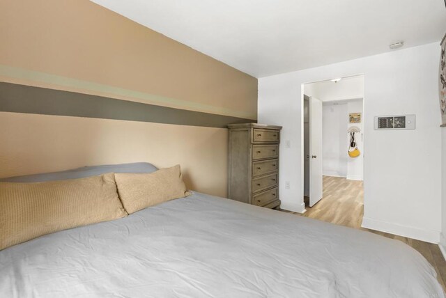 6780 Friars Rd Unit 243, San Diego, CA 92108 - bedroom with baseboards and wood finished floors